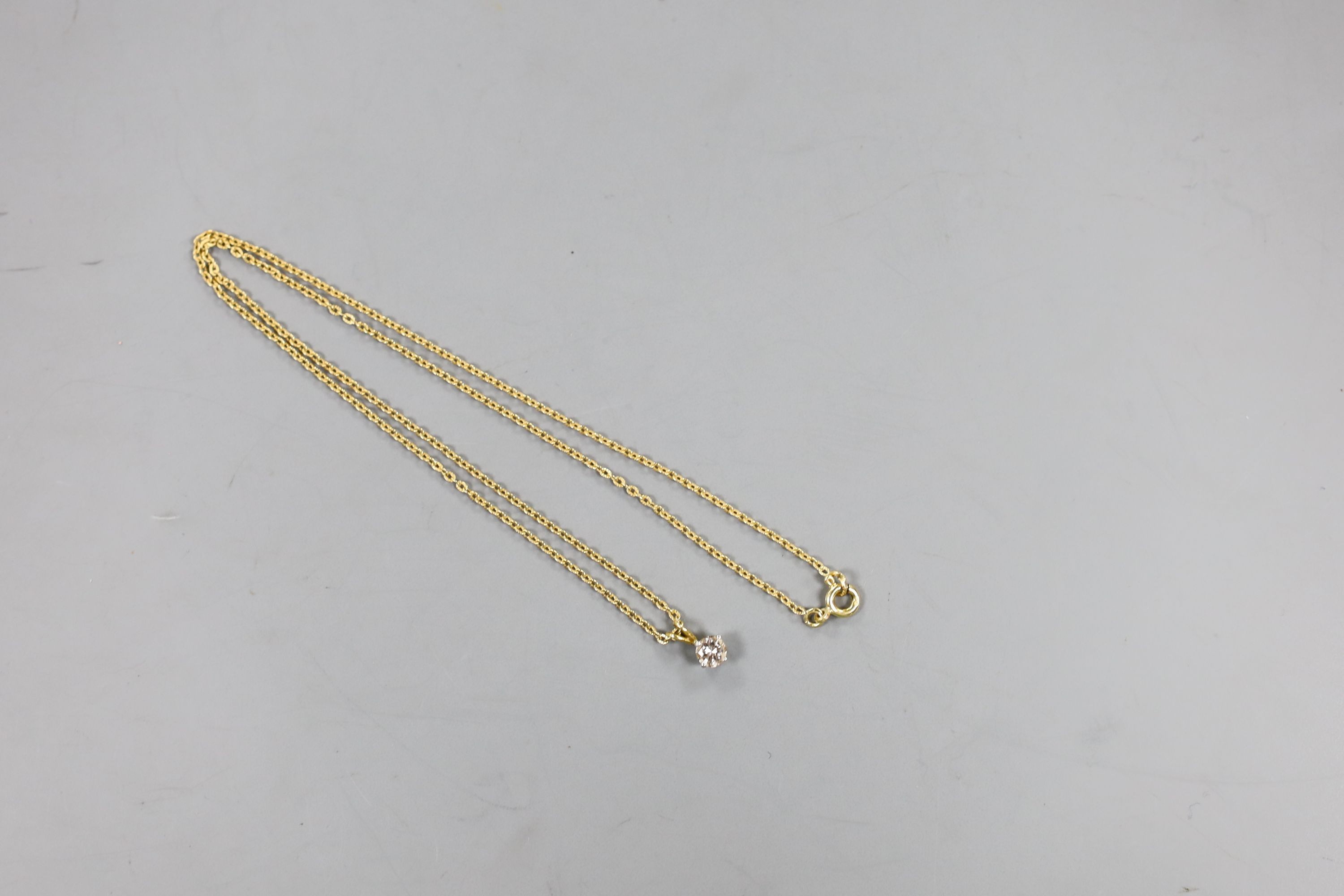 An 18ct gold and solitaire diamond set pendant, on an 18ct gold chain, chain 40cm, gross weight 2.7 grams.